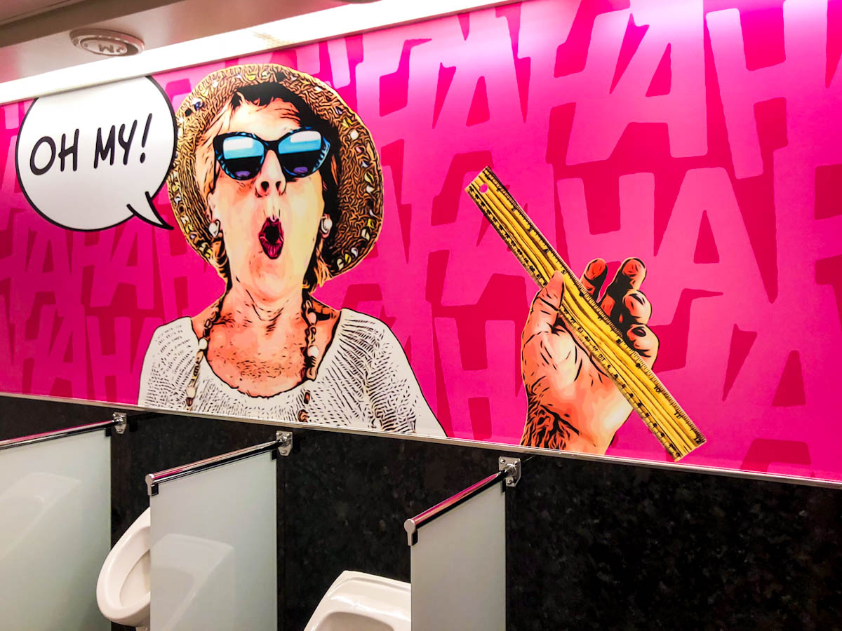 A woman with a tape measure exclaiming “OH MY”