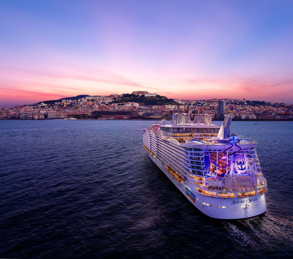 Panoramic view from sea of Naples coastline, Italy. Big cruise ships are in port, cityscape in sunny weather with blue sky and white clouds.
