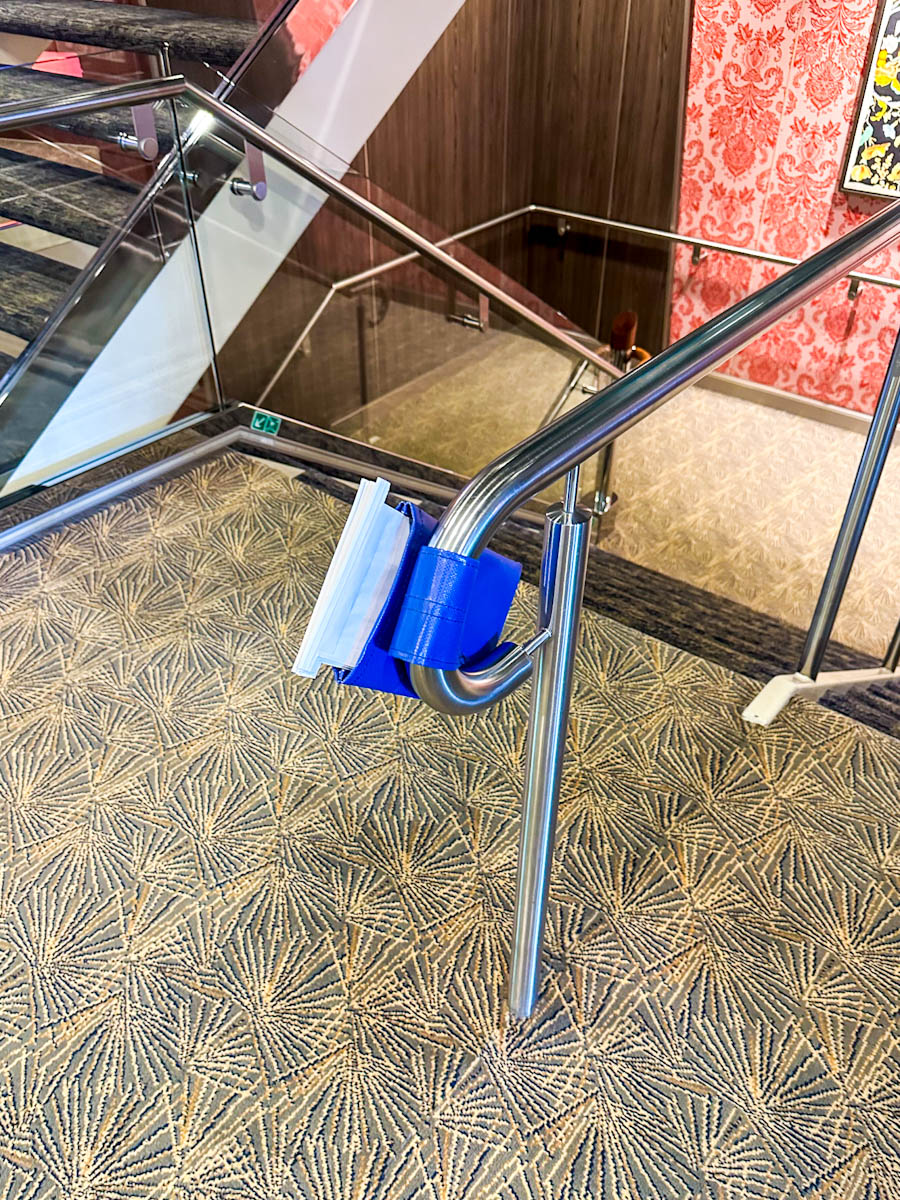 Sick bags on the end of the stairs on a cruise ship